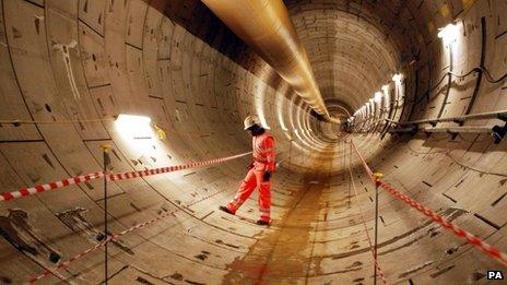 Crossrail worker Sam Agyeman, inspects the first completed section of Crossrail tunnel