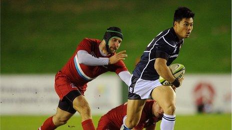 Akihito Yamada of Japan evades the tackle of Alexey Makovetskiy of Russia