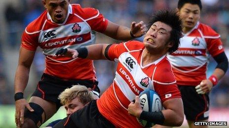 Shinya Makabe of Japan is tackled