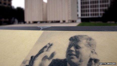 A plaque of John F Kennedy in front of the Kennedy memorial plaza in Dallas, Texas