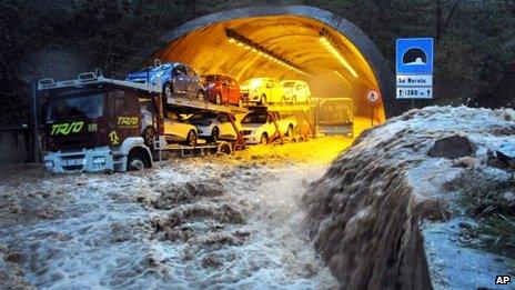 A truck and a bus are stranded by flood waters in a tunnel near Olbia