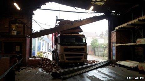 Truck surrounded by debris in warehouse