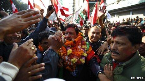 Supporters congratulate Rajan K.C., candidate of party Nepali Congress, after he defeated Nepal Maoist leader Pushpa Kamal Dahal in Kathmandu November 21, 2013