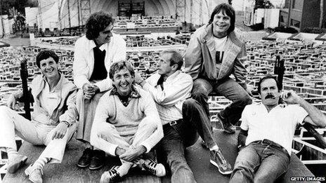 Monty Python including (left to right) Michael Palin, Terry Jones, Eric Idle, Graham Chapman (1941 - 1989), Terry Gilliam, and John Cleese, lounge at the site of their filmed live show at the Hollywood Bowl, Hollywood, California, 1982