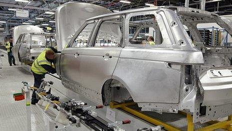 Range Rover car bodies and workers at Jaguar Land Rover, Solihull, UK