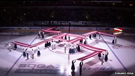 The Latvian fire cross symbol at an ice hockey match in Riga