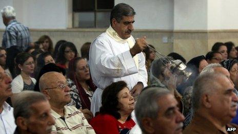 Iraqi Christians attend mass at the Mother of Continuous Aid Church in the Christian village of Ankawa, near the northern Kurdish city of Irbil, on 22 October 2013