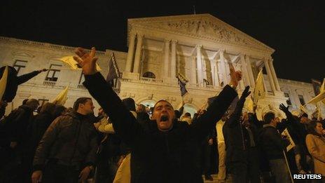 A demonstrator shouts after breaking through a line of policemen guarding the Portuguese parliament in Lisbon 21 November.