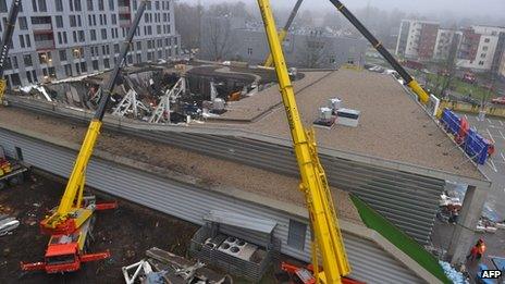 Rescuers search for survivors at the scene where the Maxima supermarket roof collapsed in Riga on November 22, 2013