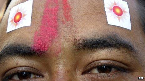 A supporter of the Communist Party of Nepal (Unified Marxist-Leninist) (CPN-UML) at a rally outside of a vote counting centre in Kathmandu on 22 November 2013.