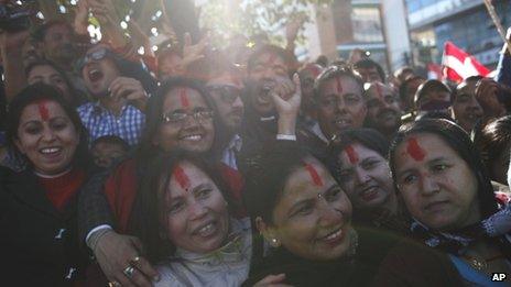Nepali Congress party supporters celebrate outside a vote counting centre after initial results showed their candidates winning in Kathmandu