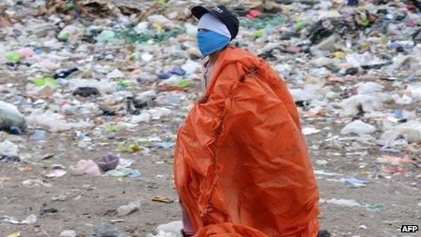 A man scavenges for items at the municipal dump in Tegucigalpa