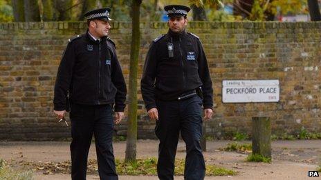 Police officers patrol near flats in Brixton, south London