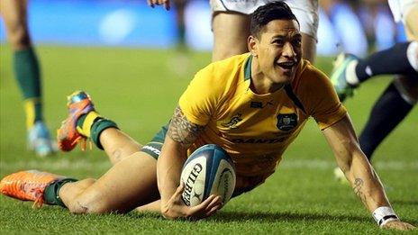 Israel Folau dives over to score a try for Australia