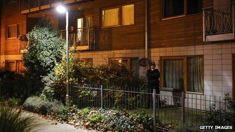 Police standing guard outside flats in south London