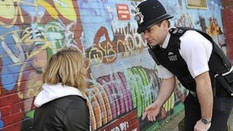 Police officer talking to girl