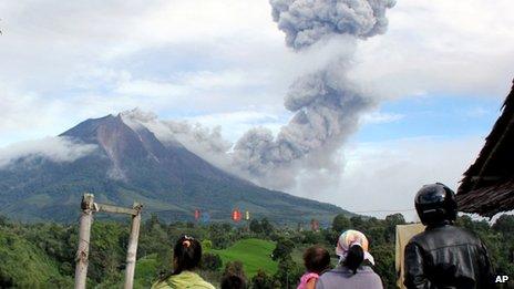 Villagers watch as Mount Sinabung sinabung spews volcanic material in Karo, North Sumatra, Indonesia, 24 November 2013