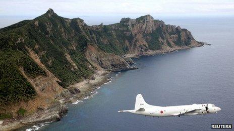 Japan Maritime Self-Defense Force's PC3 surveillance plane flies around the disputed islands in the East China Sea, known as the Senkaku isles in Japan and Diaoyu in China, in this October 13, 2011 file photo