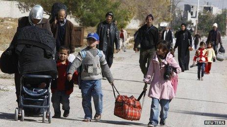 Syrian families leave the besieged town of al-Moadamiyeh