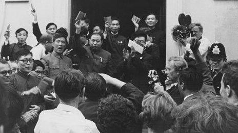 British supporters of the communist People's Republic of China listen as a Chinese diplomat exclaims Long live Chairman Mao, outside the Chinese Secretariat in Portland Place, London