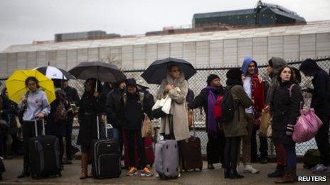 Travellers wait to board a bus in New York on 27 November 2013