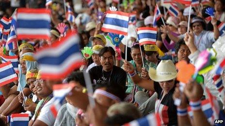 Anti-government protesters wave national flags during a protest at Government Complex in Bangkok on 28 November 2013