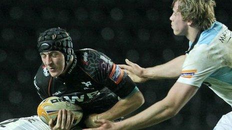Sam Davies of Ospreys is tackled by Sean Lamont and Jonny Gray