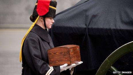 A member of the Household Cavalry Mounted Regiment carries a ceremonial casket of "sacred soil" from First World War battlefields
