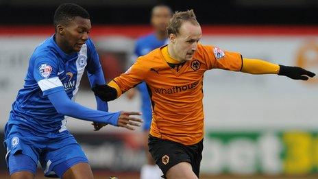 Peterborough United's Kgosi Nthle (left) and Wolverhampton Wanderers' Leigh Griffiths (right) battle for the ball.