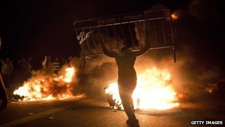 Israel Bedouins burn a police barricade during a protest on 30 November 2013 near Hura, Israel