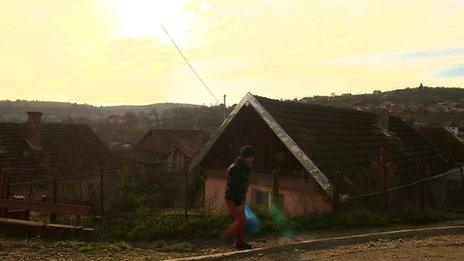 A man walks across a road in Transylvania, Romania