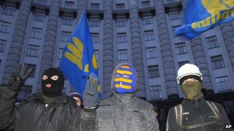 Protesters stand in front of Ukraine's main government building in Kiev, on 2 December.