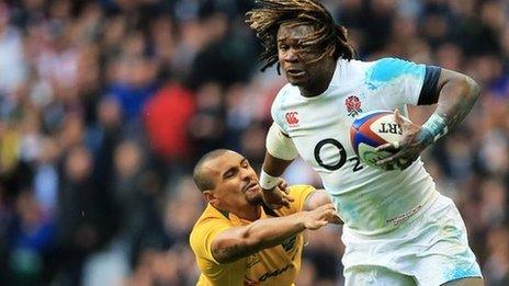 Marland Yarde of England evades a tackle from Will Genia of Australia