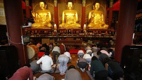 Parents pray for their children taking exams in Seoul