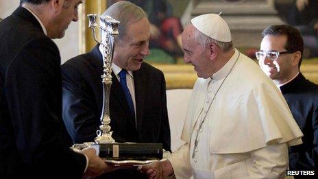 Pope Francis (L) talks with Israeli Prime Minister Benjamin Netanyahu as he was presented with a Menorah during a private audience at the Vatican December 2, 2013