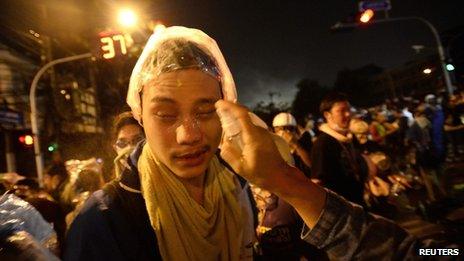 Anti-government protesters are treated after Thai riot police fired tear gas as protesters attacked Government House in Bangkok December 2, 2013