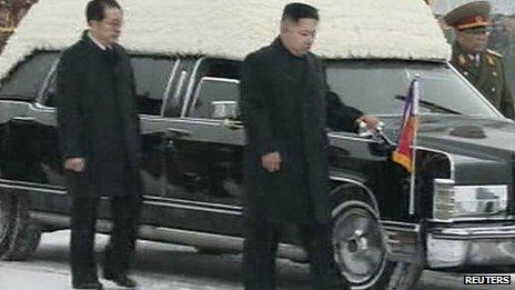 Kim Jong-un and his uncle Chang Song-thaek (L) accompany the hearse carrying the coffin of late North Korean leader Kim Jong-il during his funeral procession in Pyongyang on 28 December 2011