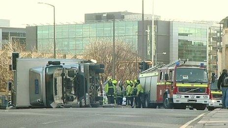 Lorry on its side and fire engine