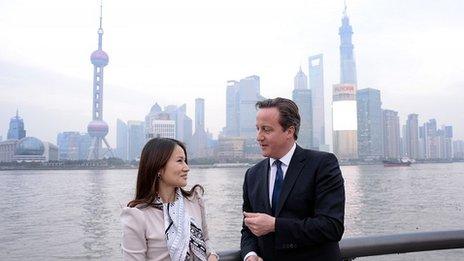 Prime Minister David Cameron walks along The Bund in Shanghai with Lisa Pan, Vice President of Rekoo, one of Asia"s largest social gaming companies,