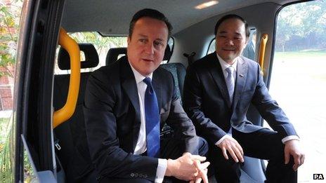 Prime Minister David Cameron sits in a London black cab with Geely Chairman Li Shufu who intends to operate London taxis in Shanghai.