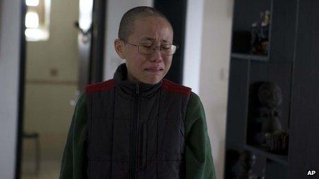 Liu Xia, wife of 2010 Nobel Peace Prize winner Liu Xiaobo, reacts emotionally to an unexpected visit by journalists at her home in Beijing, China, 6 December 2012