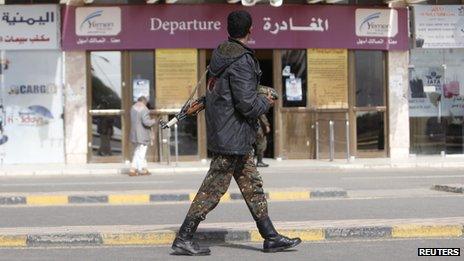 A police trooper walks outside the departure lounge Sanaa International Airport on 7 August 2013