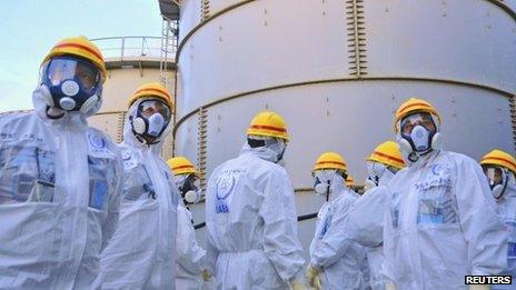 A team of International Atomic Energy Agency (IAEA) experts check out water storage tanks at Fukushima