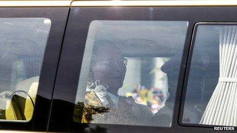 Thailand's King Bhumibol Adulyadej (L) and Crown Prince Maha Vajiralongkorn (R) arrive in a van at Klai Kangwon Palace, Hua Hin, Prachuap Khiri Khan province, 5 December 2013