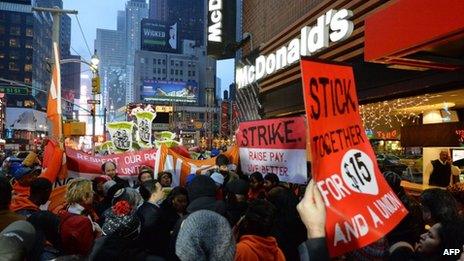 Demonstrators protest outside a McDonald's restaurant near New York's Times Square on 5 December 2013