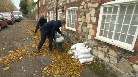 Residents put sandbags outside their homes in Sandwich, Kent