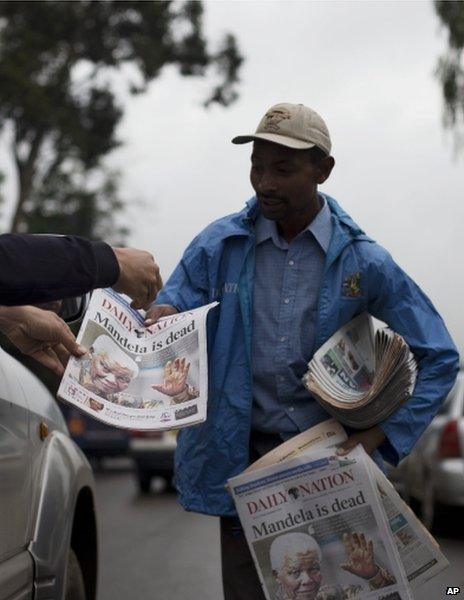 A newspaper vendor in Nairobi, Kenya, 6 December