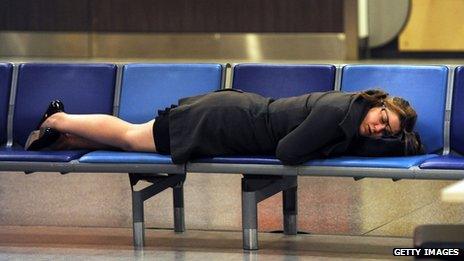 A woman sleeps at Gatwick Airport