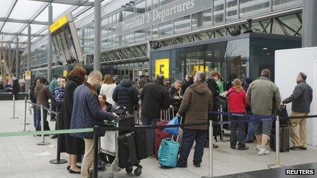 Passengers queue outside Terminal 3 at Heathrow Airport in west London