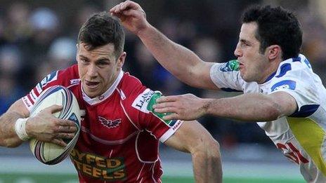 Gareth Davies of Scarlets is tackled by Thierry Lacrampe